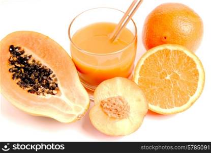 a glass of orange juice with cut oranges