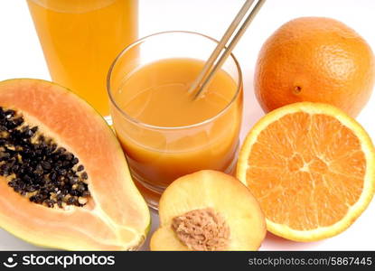 a glass of orange juice with cut oranges