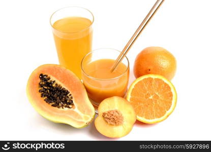 a glass of orange juice with cut oranges