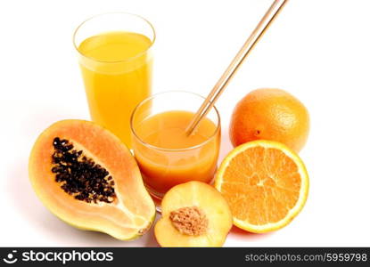 a glass of orange juice with cut oranges