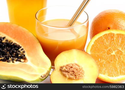 a glass of orange juice with cut oranges