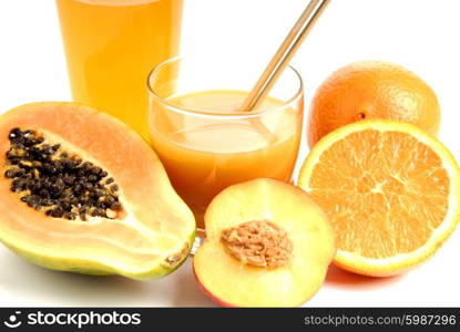 a glass of orange juice with cut oranges