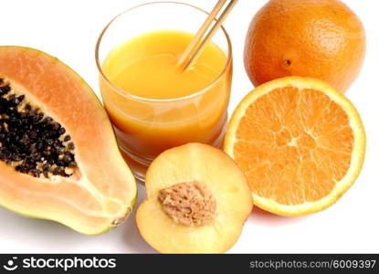 a glass of orange juice with cut oranges