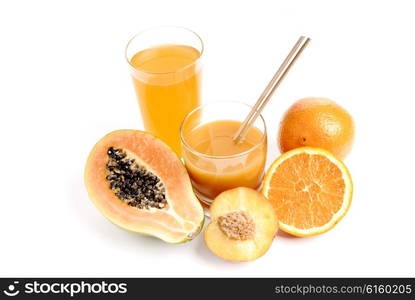 a glass of orange juice with cut oranges