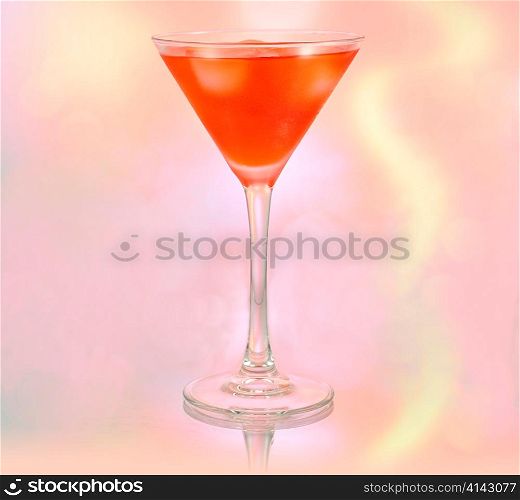 a glass of red cocktail with ice