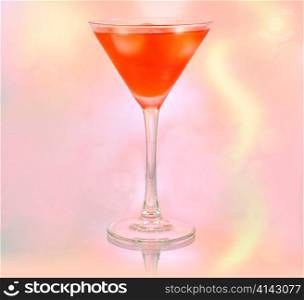 a glass of red cocktail with ice