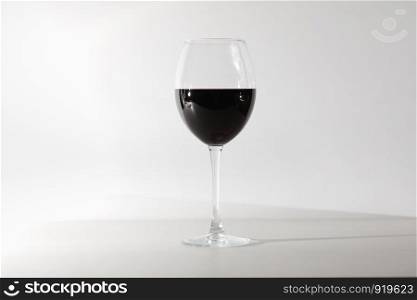 A glass of red wine. Copy space. Concept restaurant, alcohol, party. Glass of red wine isolated on white background. A glass of red wine. Copy space.