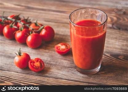 A glass of tomato juice with cherry tomatoes