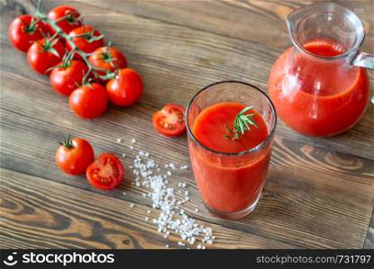 A glass of tomato juice with cherry tomatoes