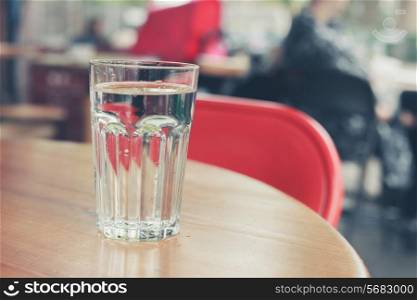 A glass of water on a table outside in the street