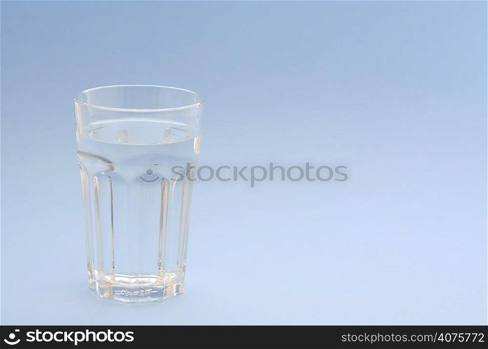 A glass of water with blue background