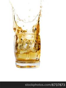 A glass of whiskey with ice cube splash