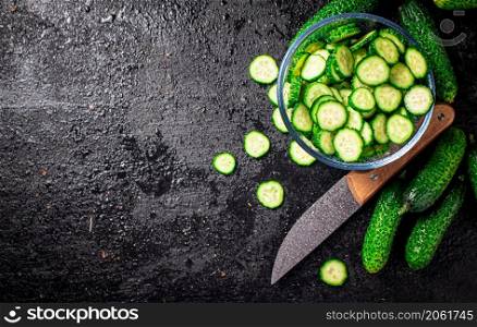 A glass plate with cucumber pieces. On a black background. High quality photo. A glass plate with cucumber pieces.