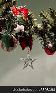 A glass star pending from a christmas decoration