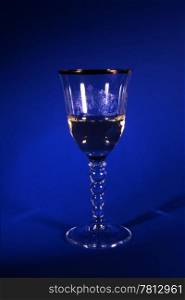 A glass white wine isolated on blue background