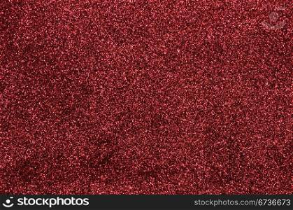 A glittery red paper decorative background