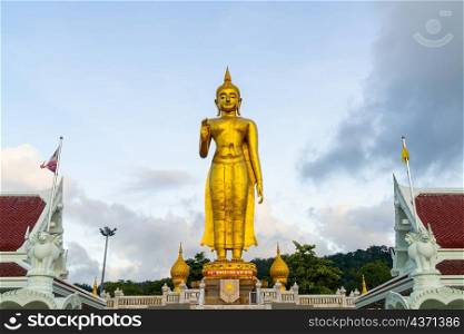 A golden buddha statue with sky on the mountain top at Hat Yai municipality public park, Songkhla Province, Thailand