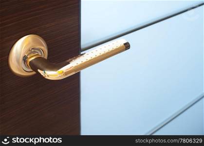 a golden door handle, a closeup shot
