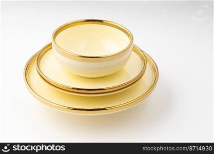 A golden luxury ceramic kitchen utensils on a white background. Golden luxury ceramic kitchen utensils on a white background