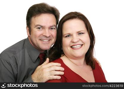 A good looking, loving couple in red - her dress, his tie. Isolated on white.