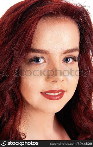 A gorgeous face of a woman with red hair and blue eye&rsquo;s, looking intothe camera, isolated for white background.