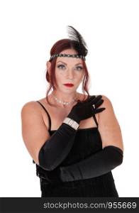 A gorgeous woman wearing a 20 century black dress with the headband and black cloves, isolated for white background