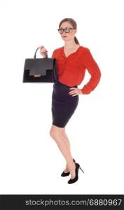 A gorgeous young business woman standing in a red blouse and black skirt, holding her black purse with glasses isolated for white background