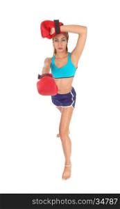 A gorgeous young woman in exercise outfit with red boxing clovesstanding in full length isolated for white background.
