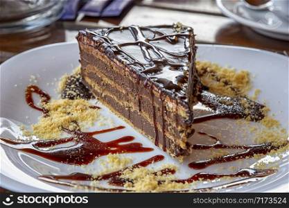 a gourmet piece of chocolate cake, torte on a decorated plate. Selective focus