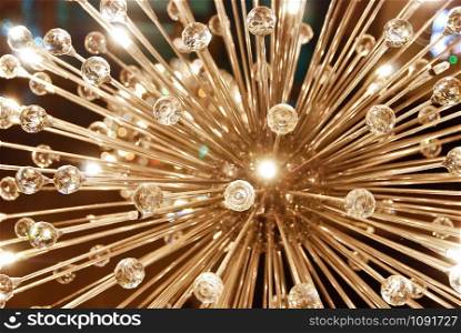 A grand glass shiny ceiling chandelier in the shape of dandelion