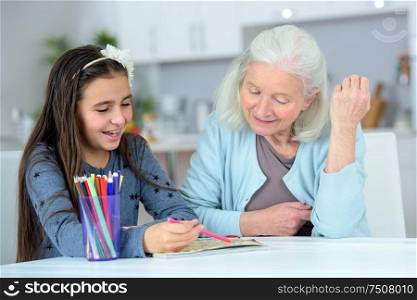 a grandma and grand-daughter drawing