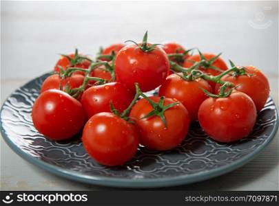 a grape of cherry tomatoes on the blue plate