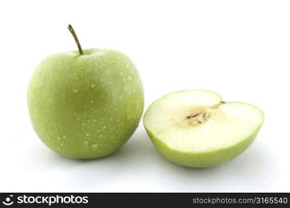 A green apple with half a green apple