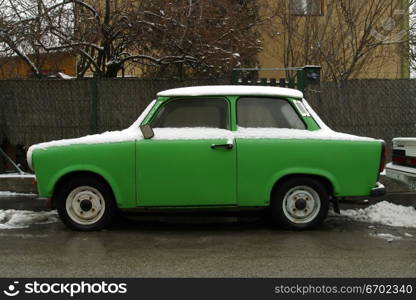 A green car frozen to the road.