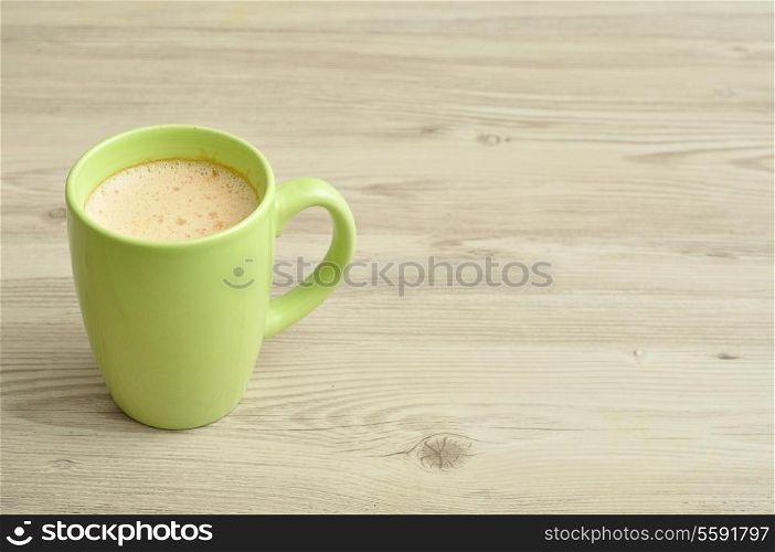 A green mug of coffee