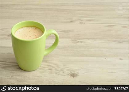 A green mug of coffee