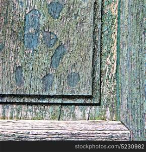 a green piece of wood brown knocker and wood door cairate varese italy