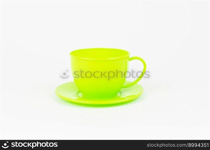 a green toy plastic cup with a plate on a white background. green toy plastic cup with a plate on a white background