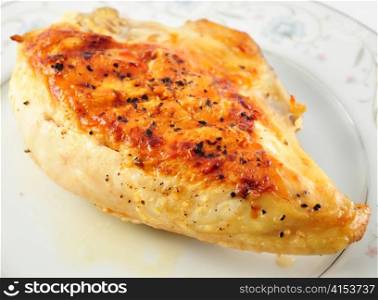 a Grilled chicken breast on a plate , close up