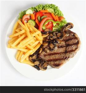 A grilled ribeye steak served with mushrooms, chips (french fries) and a garden salad of lettuce, cucumber, baby carrot and capsicum, viewed from above