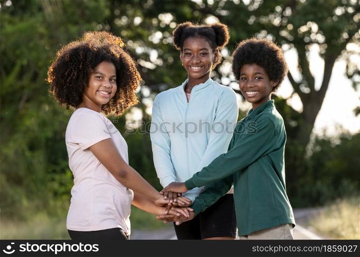 A Group of afro children curly hair stacking of hands