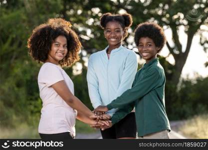 A Group of afro children curly hair stacking of hands