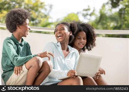 A group of afro children curly hair style conversation conversation and using laptop at staircase of building.