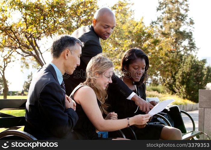 A group of business people in a park setting