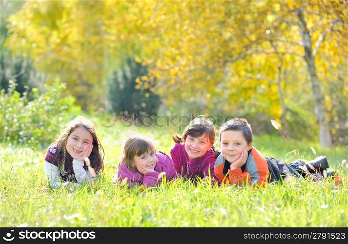 A group of children laying down in the grass