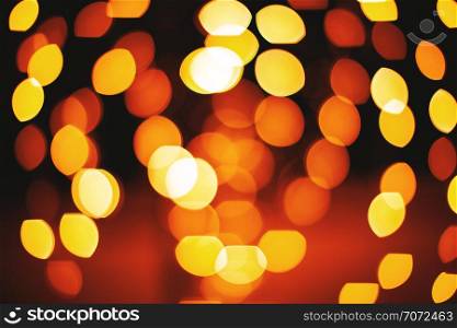 A group of circle and oval shape from red and yellow lights defocused abstract background, Lens aperture bokeh blurred effect