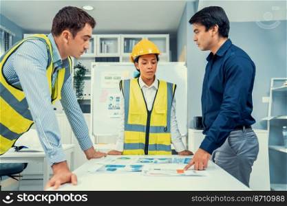 A group of competent engineers and employer discuss plans in the office. Architectural investor, businessman, and engineer discussing blueprints.. A group of competent engineers and employer discuss plans in the office.