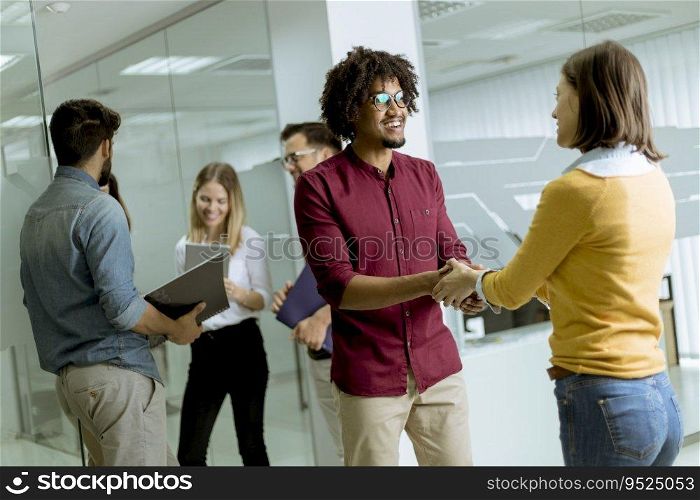 A group of creative young people standing in the modern startup office