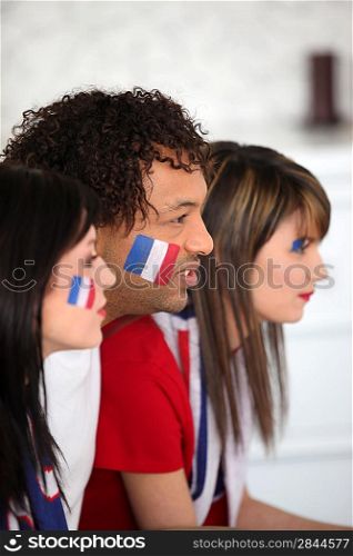 A group of French supporters watching a football game