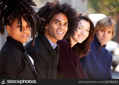 A group of friends in the city - shallow depth of field with focus on African American